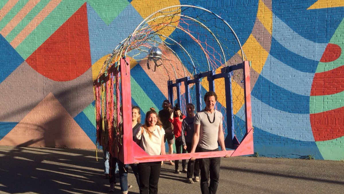 Art students holding lobster trap art